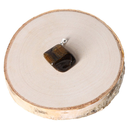 Multicolor tumbled Tiger's Eye pendant on a wooden surface, showcasing its polished texture and natural gemstone beauty.