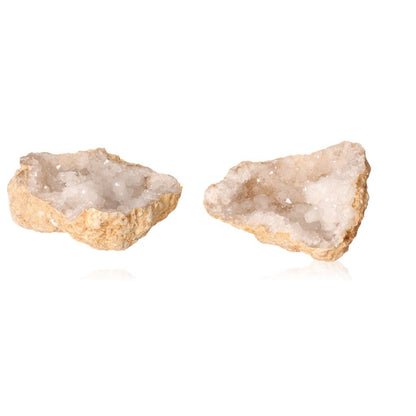 Milky quartz geode halves revealing sparkling white crystals, known for purifying energy and enhancing focus.