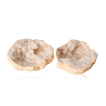 Milky quartz geode with sparkling white crystals and rugged outer shell showcasing cleansing and energy-balancing properties.