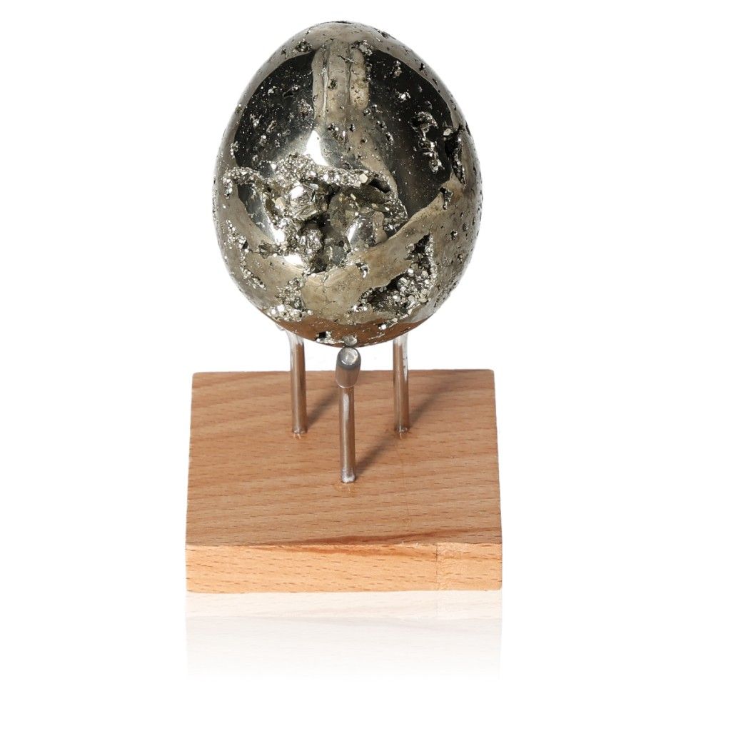 Shiny pyrite egg on a wooden stand, symbolizing independence and motivation.