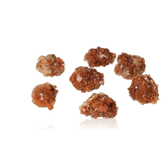 Aragonite small druzes with cluster formations in warm amber shades, known for grounding energy and harmonizing spaces.