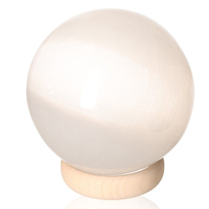 Selenite sphere on wooden stand, premium 10cm crystal from Sylvia Crystals for mindfulness and spiritual growth.