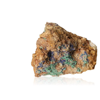 Raw malachite druze on white background with earthy tones and green mineral formations