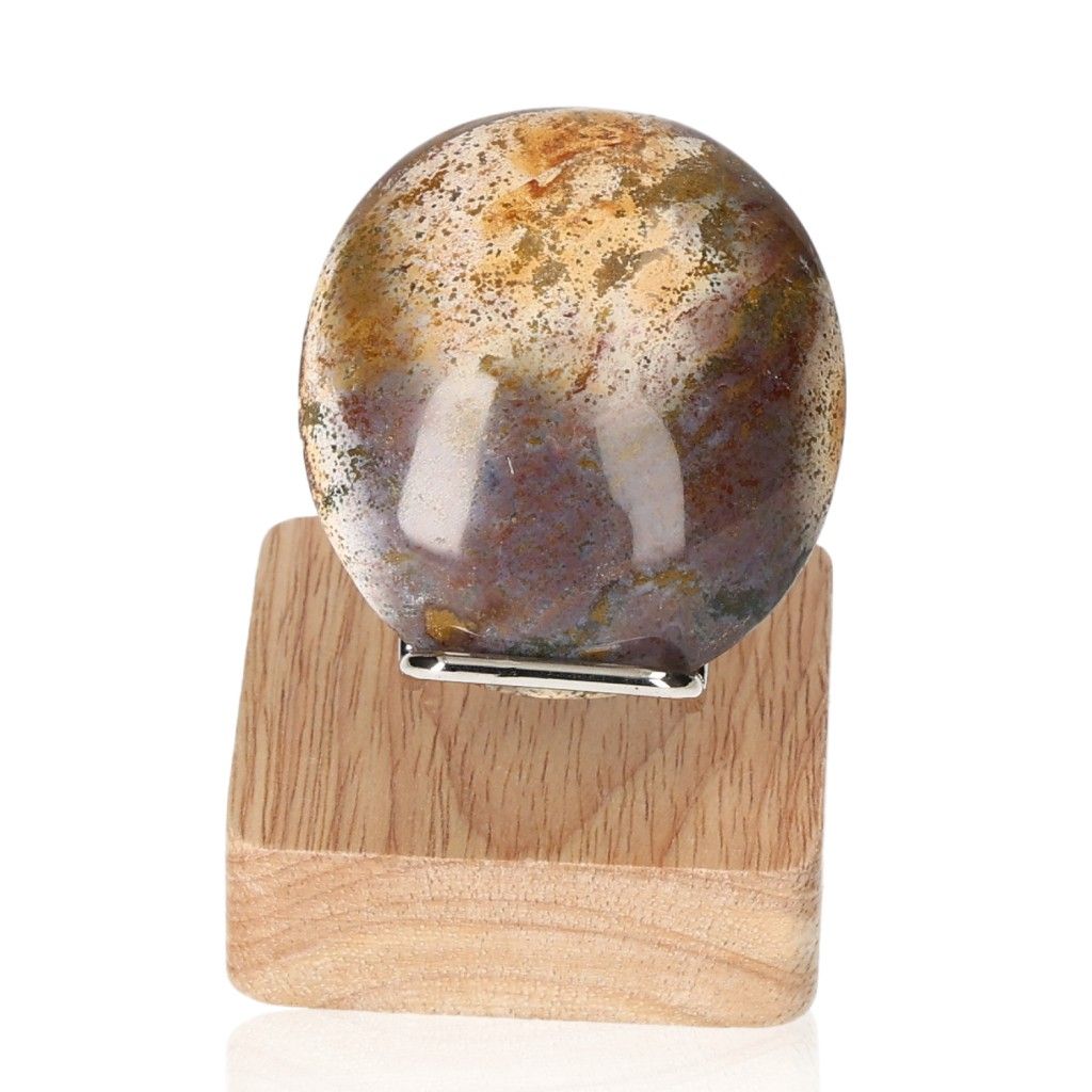 Ocean Jasper stone on wooden stand, known for promoting peace and healing, against a white background.