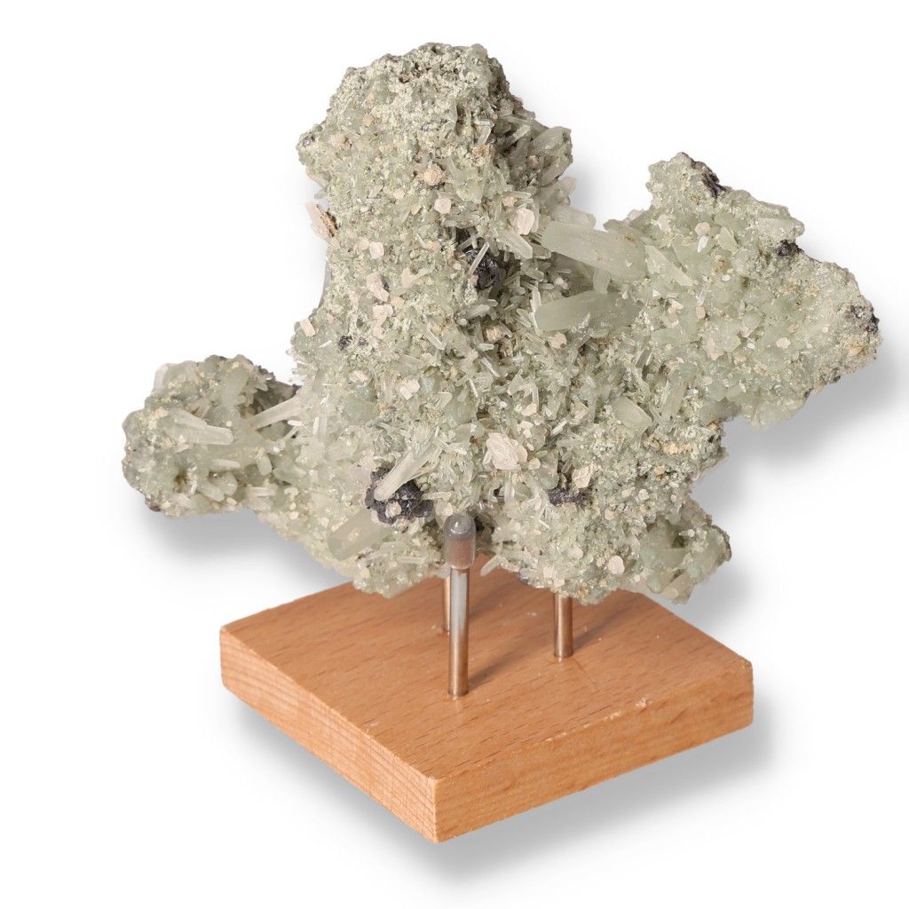 Green quartz mineral specimen on a wooden stand showcasing its unique texture and properties for chakra and zodiac energy balance.