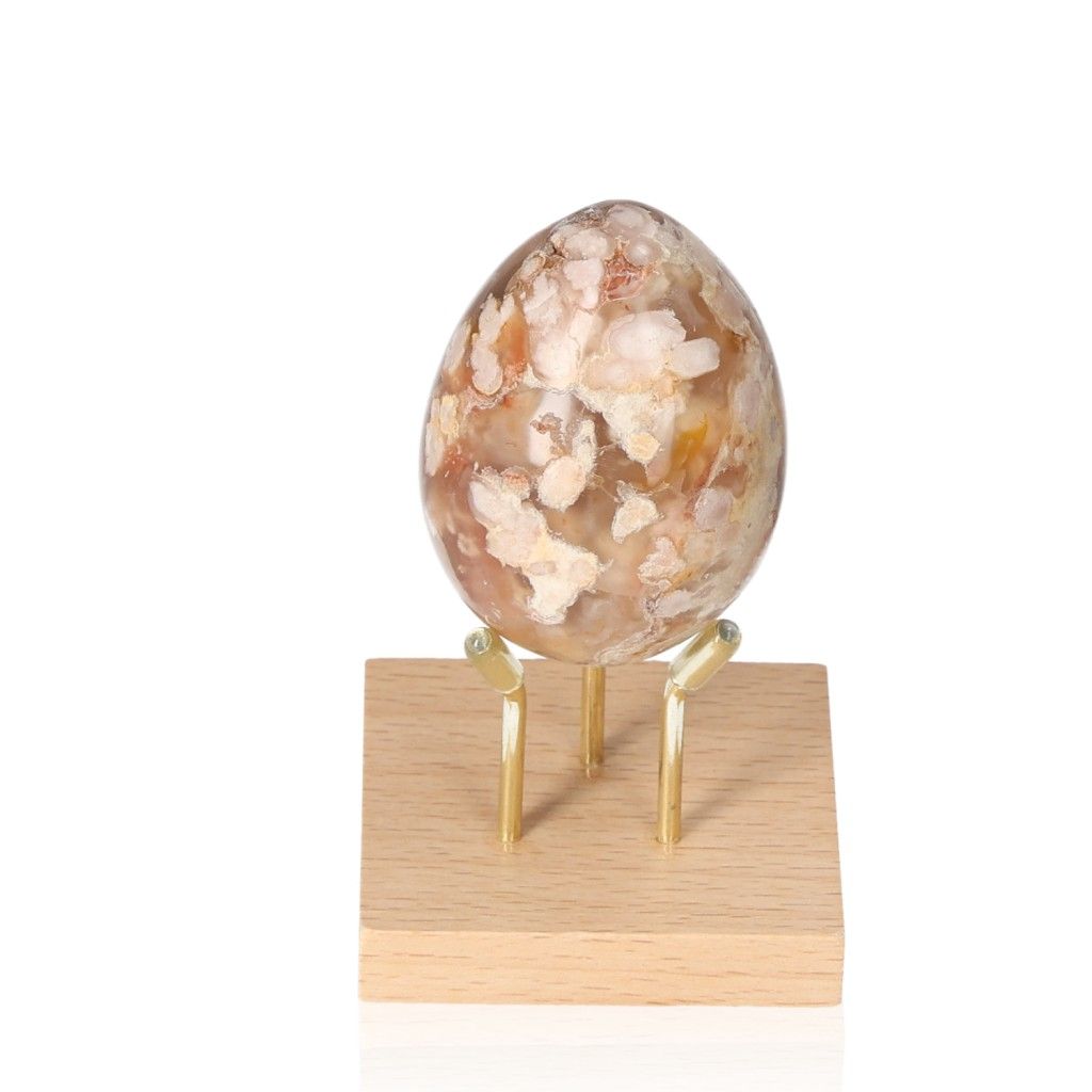 Flower Agate Egg displaying natural patterns on a wooden stand