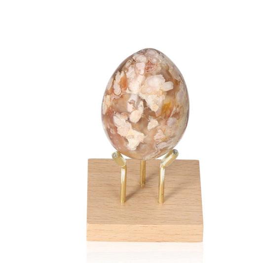 Flower Agate Egg displaying natural patterns on a wooden stand