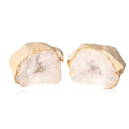 Open quartz geode revealing cloudy white crystals, known for purifying energy and enhancing tranquility and clarity.