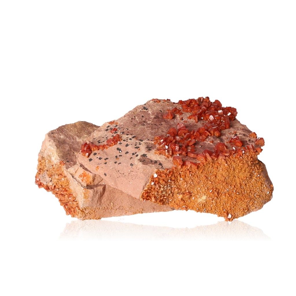 Vanadinite Druze with vivid reddish-orange hexagonal crystals on a rocky surface, showcasing geometric shapes and bold colors.