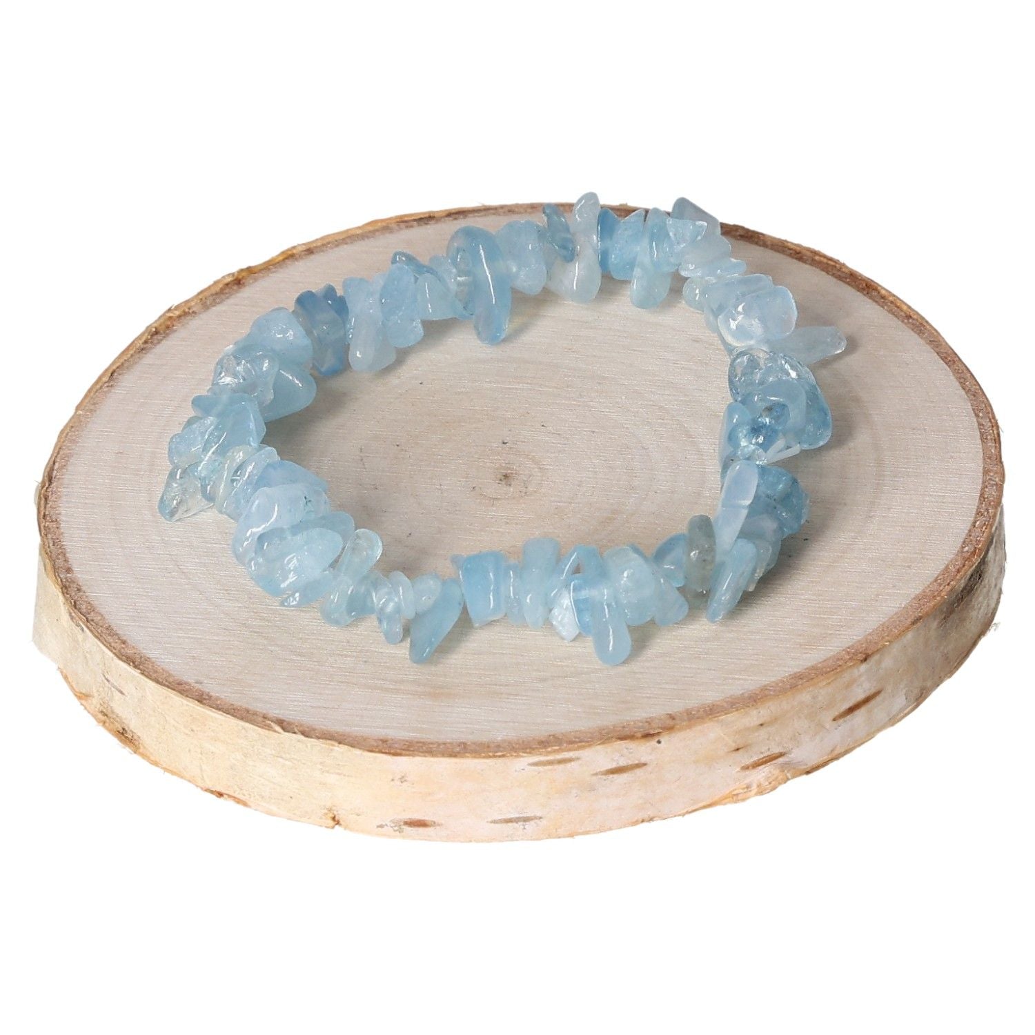 Aquamarine chip bracelet displayed on a natural wooden slice background, showcasing its delicate blue gemstone beads.