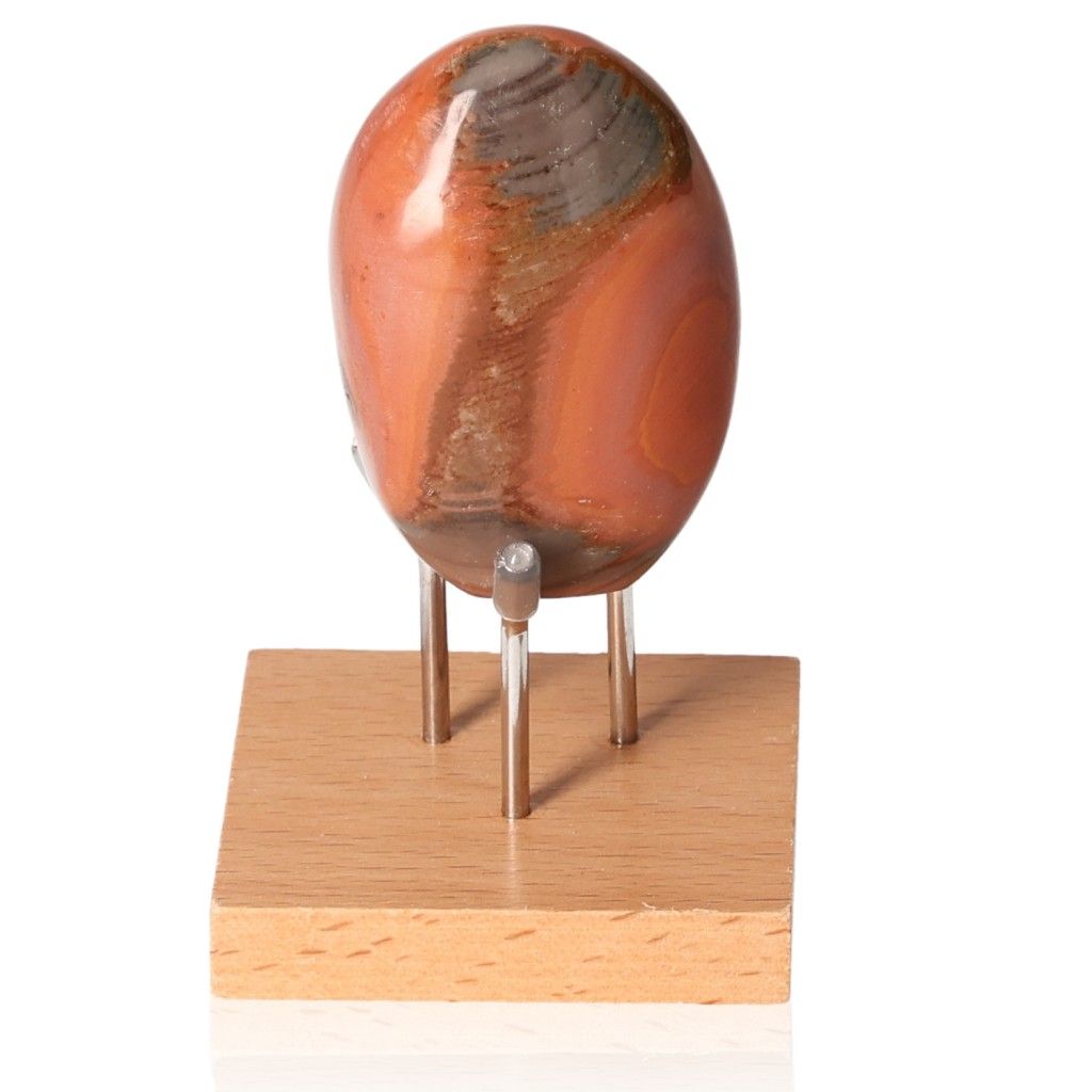 Polychrome Jasper Free Form with vibrant red, orange, and brown patterns displayed on a wooden stand