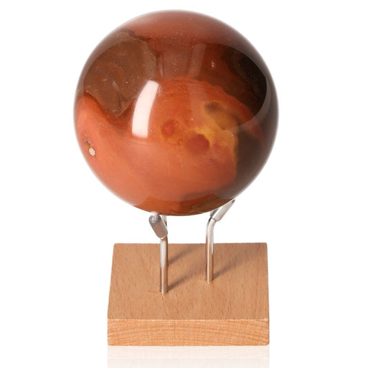 Polychrome Jasper Sphere with vibrant red and brown color patterns displayed on a wooden stand.