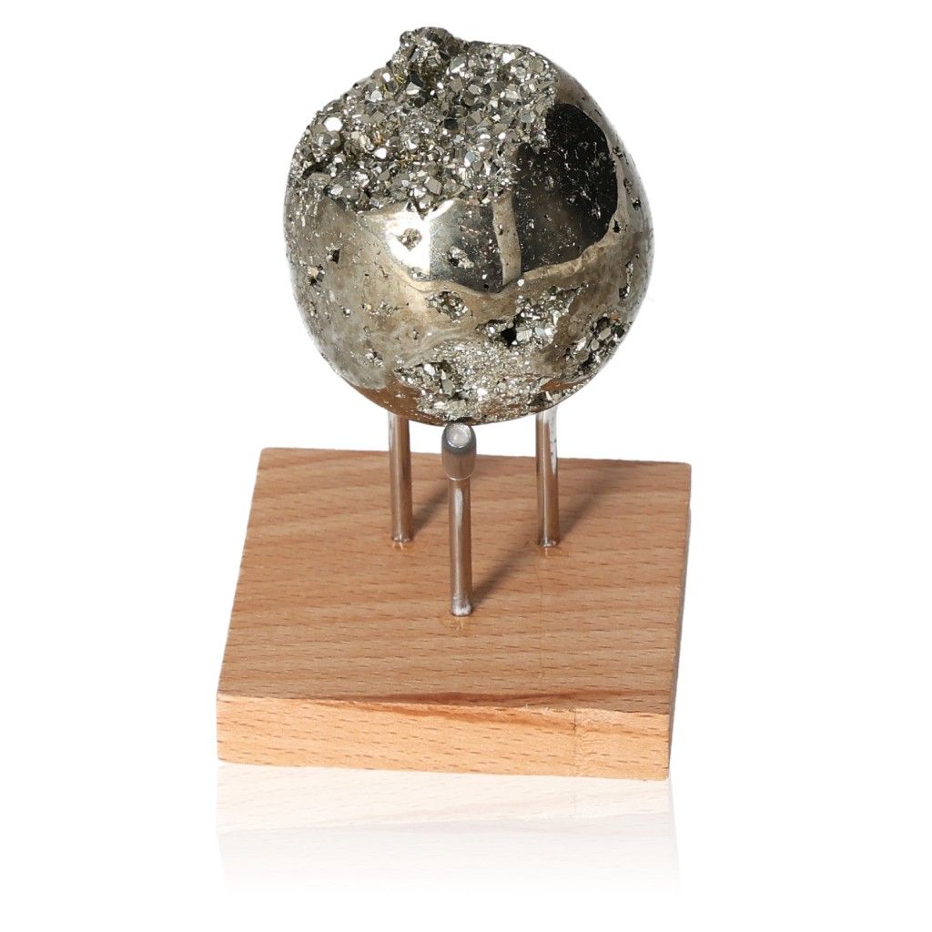 Pyrite egg on wooden stand, promoting independence, courage, and motivation in goal achievement.