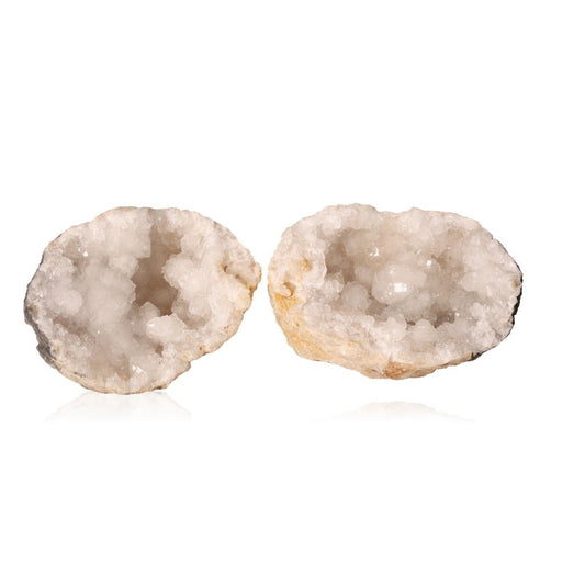 Milky quartz geode halves showing sparkling cloudy white crystals inside rugged earthy shells, ideal for energy cleansing and focus.