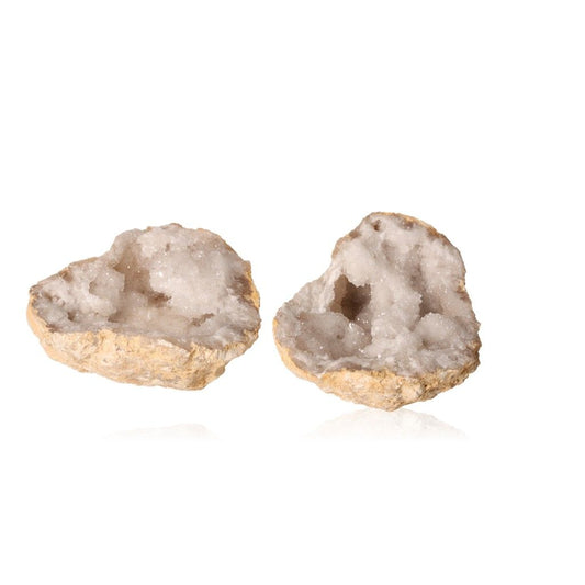 Milky quartz geode halves showcasing sparkling white crystals, perfect for enhancing tranquility and positive energy in spaces.