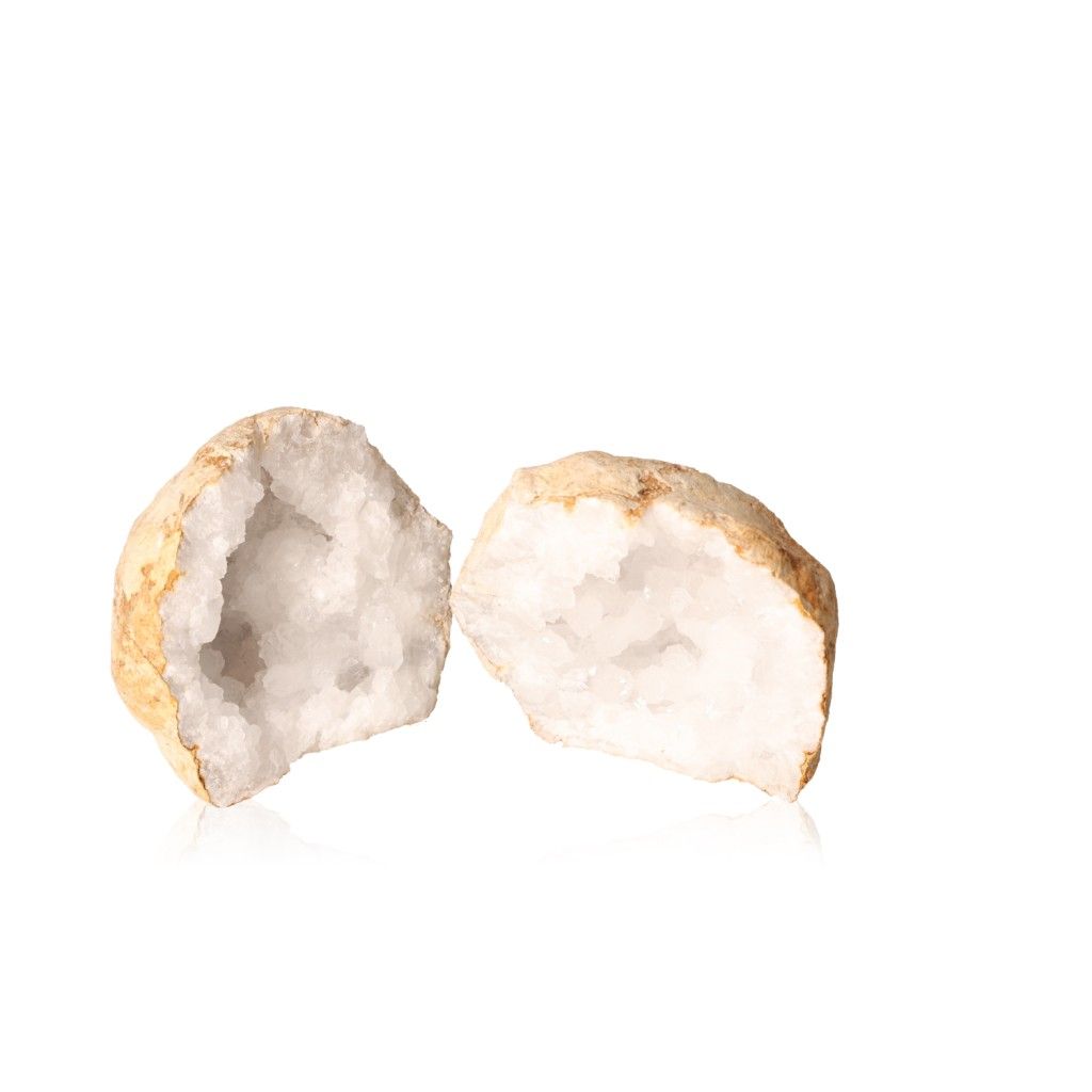 Open quartz geode showing sparkling milky white crystals against a white background, enhancing clarity and tranquility.