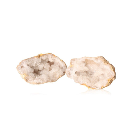 Open milky quartz geodes showcasing sparkling, cloudy white crystals, known for purifying energy and enhancing clarity and focus.