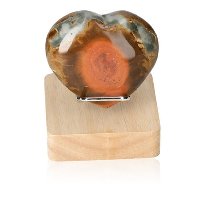 Polychrome Jasper Heart with vibrant red, orange, and brown patterns on a wooden stand, known for grounding and energizing properties.