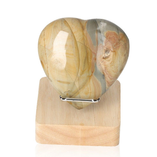 Polychrome Jasper Heart with vibrant color patterns on a wooden stand, showcasing its unique banded appearance and grounding properties.