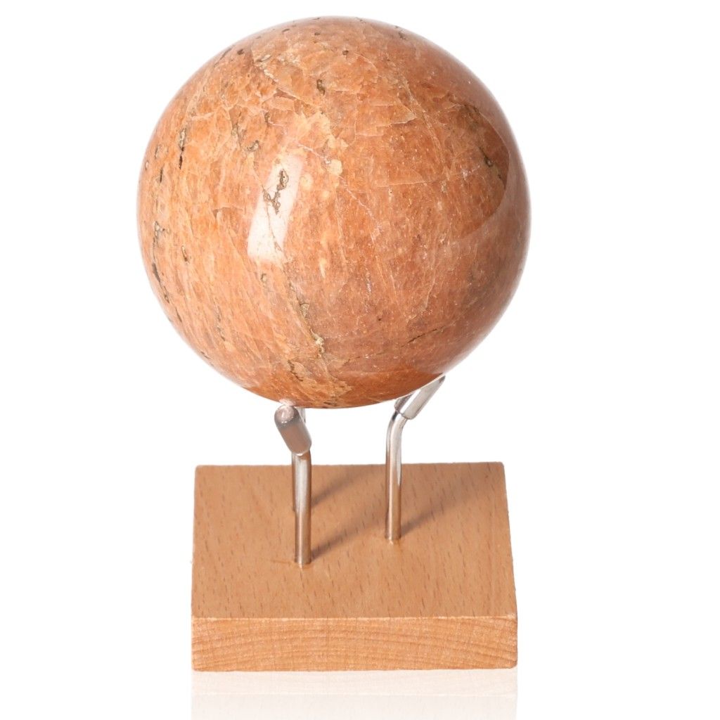 Peach Moonstone Sphere on stand, showcasing its soft peach hue, known for calming the mind and promoting emotional healing.