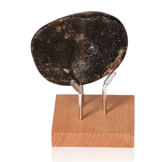 Septarian "Dragon Stone" mineral on wooden display stand showcasing unique texture and color, symbolizing power and endurance.