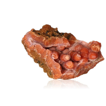 Red calcite stalactite with layered structure showcasing earthy tones and natural beauty.