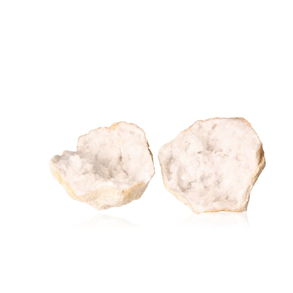 Milky quartz geodes with cloudy white crystals, showcasing their rugged outer shell and sparkling interior.