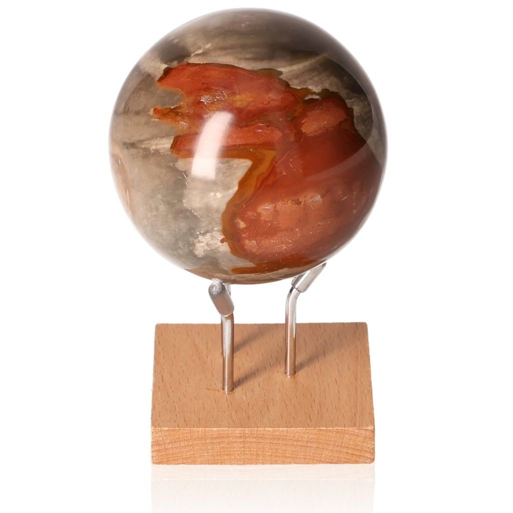 Polychrome Jasper Sphere with vibrant red and brown colors on wood stand, showcasing unique banded patterns and energizing properties.