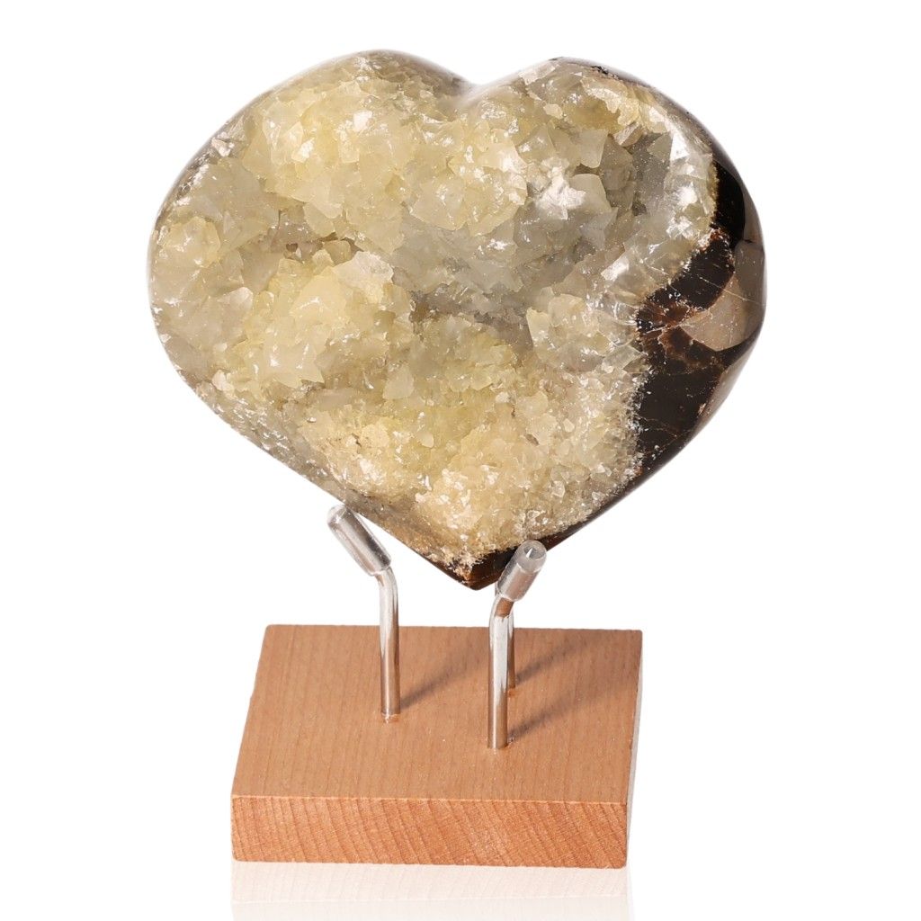 Heart-shaped septarian stone on wooden stand showcasing unique mineral pattern and rich symbolism.