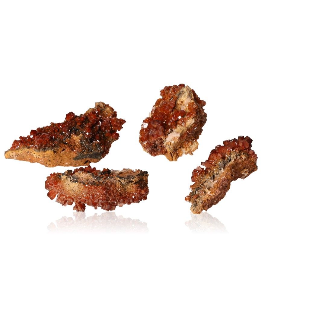 Four small vanadinite druzes with reddish-brown hexagonal crystals and glassy surface, enhancing focus and motivation.