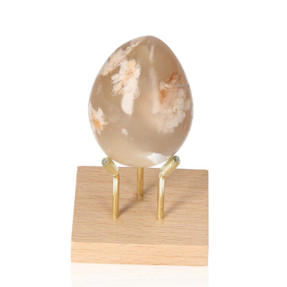 Flower Agate Egg on a wooden stand for emotional harmony and energy balance