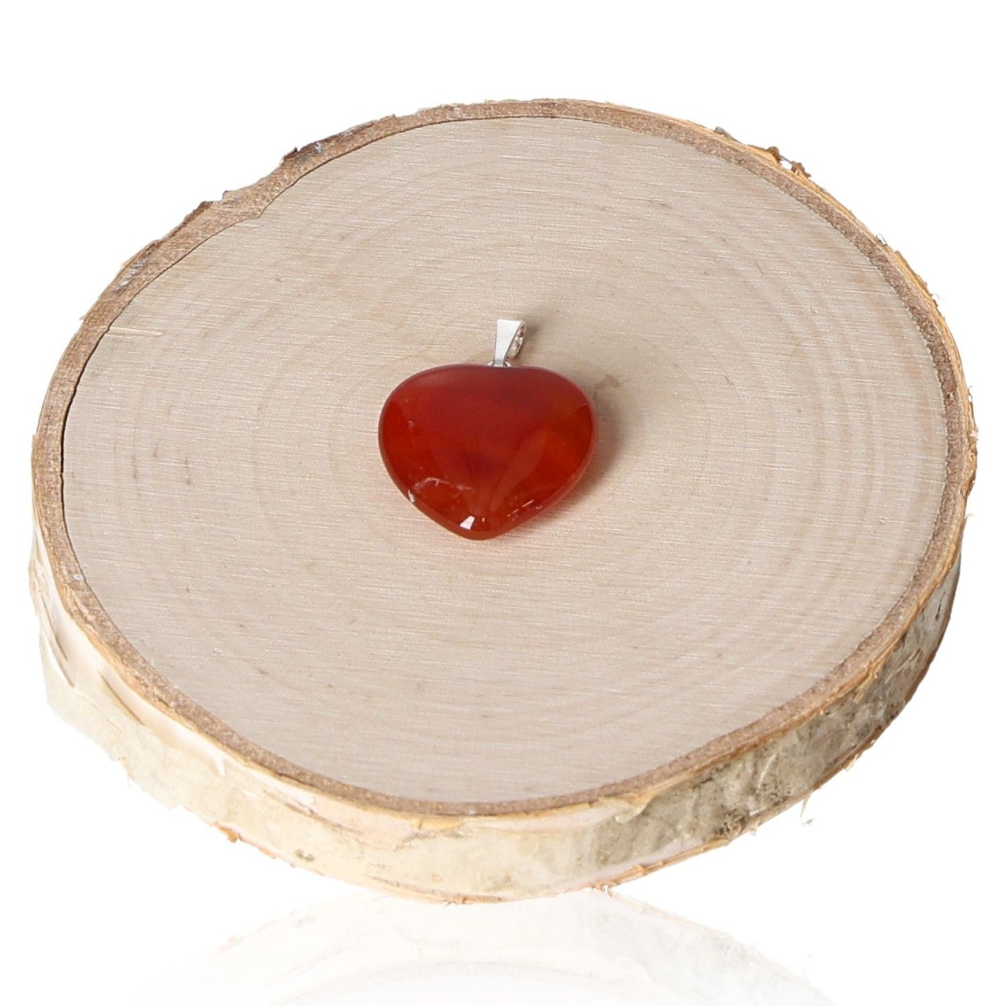 "Carnelian heart pendant 20mm on wood slice display"