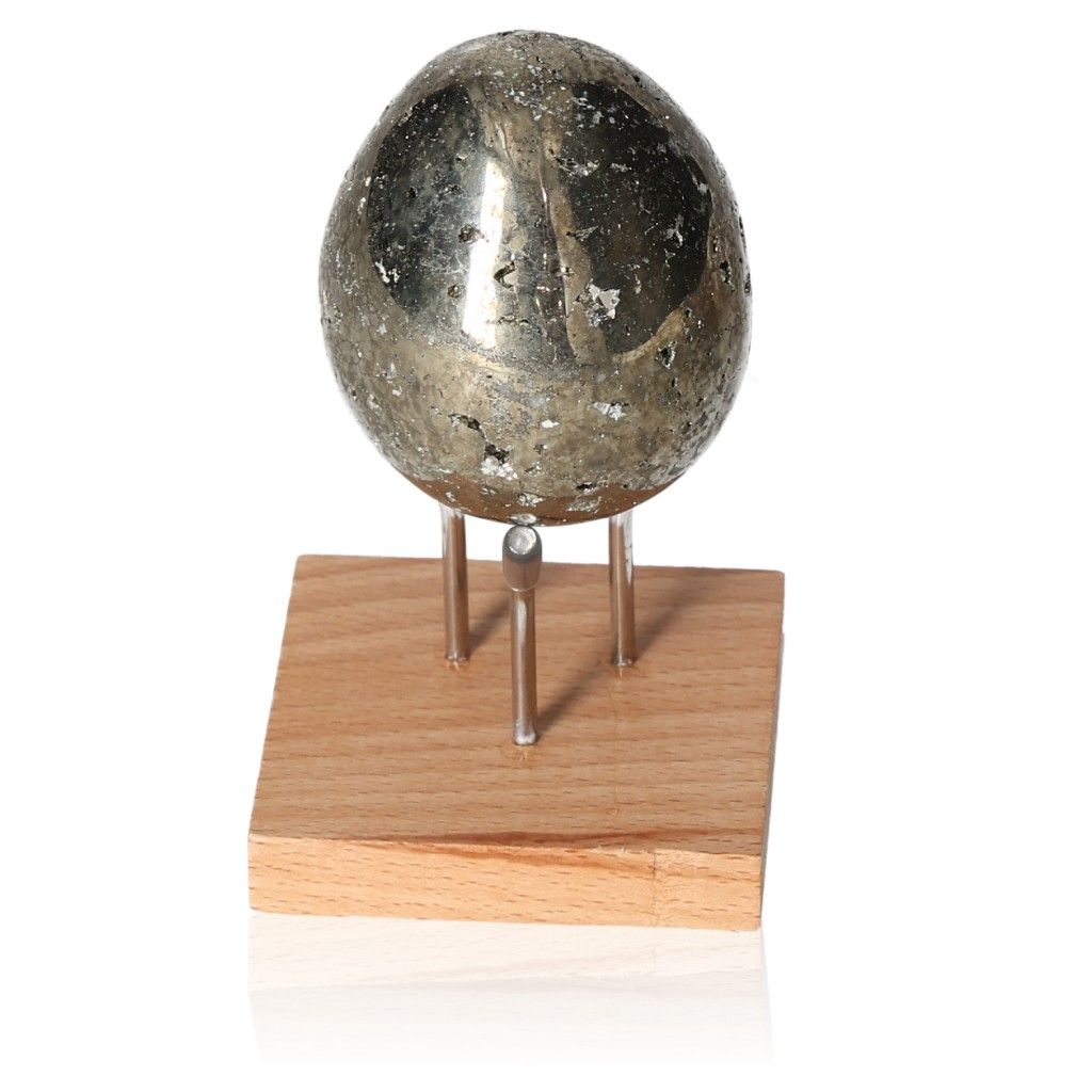 Shiny pyrite egg on a wooden display stand, symbolizing courage and initiative. Ideal for mental independence and goal achievement.