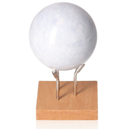 Blue Calcite Sphere on wooden stand, ideal for stress relief, communication enhancement, and emotional healing.