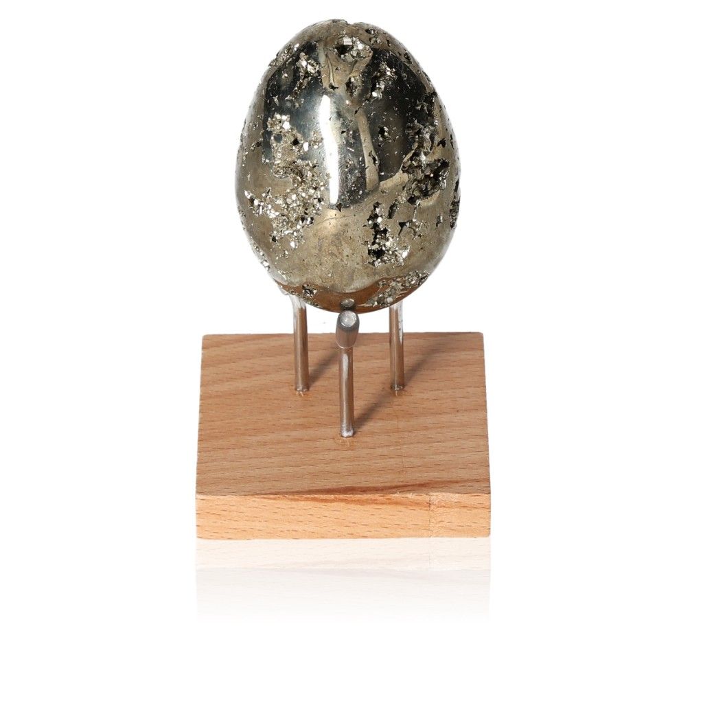 Pyrite egg displayed on wooden stand, promotes independence and inspires new ideas for personal growth and achievement.