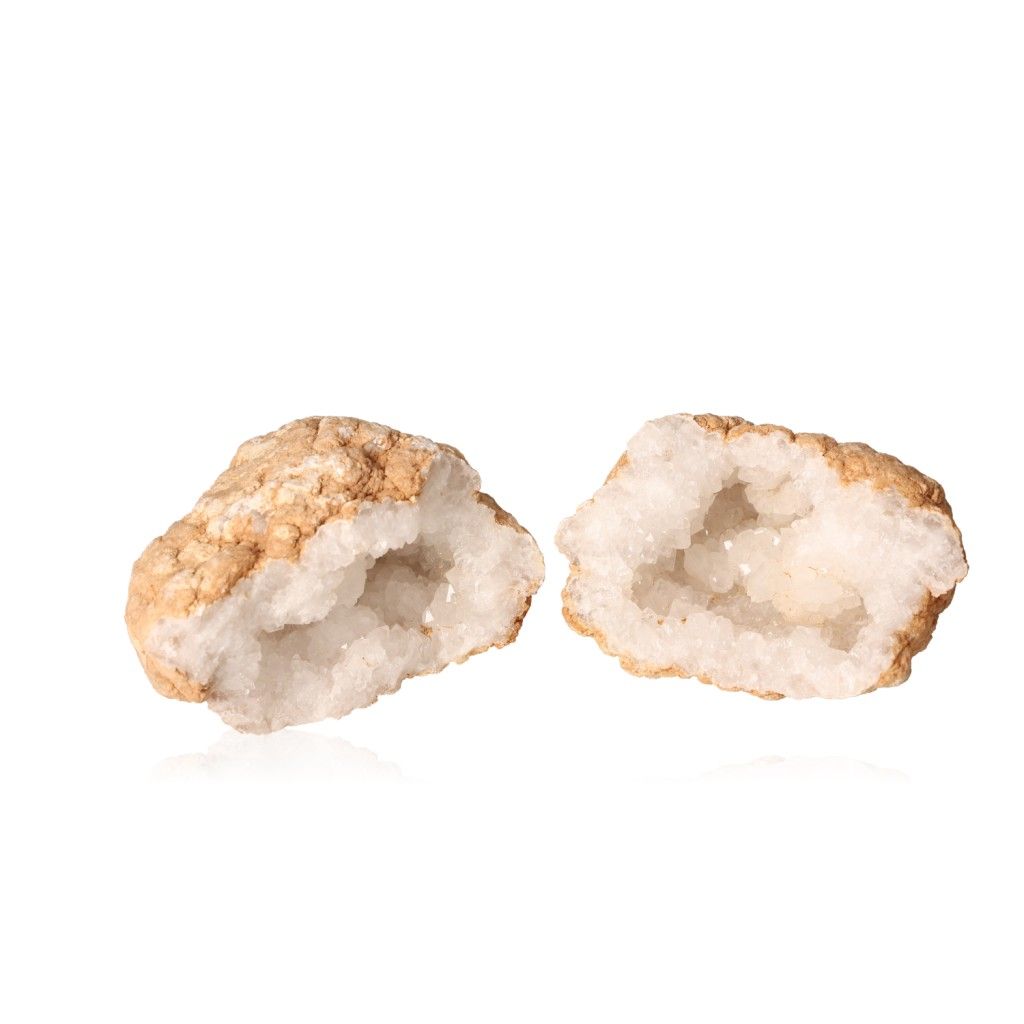 Milky quartz geodes with earthy shell and sparkling white crystals, known for purifying, amplifying energy, and promoting tranquility.