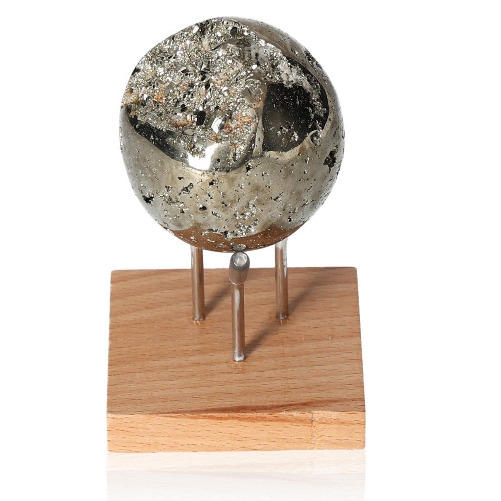 Shiny pyrite sphere on wooden stand, symbolizing courage and motivation, ideal for inspiring new ideas and achieving goals.