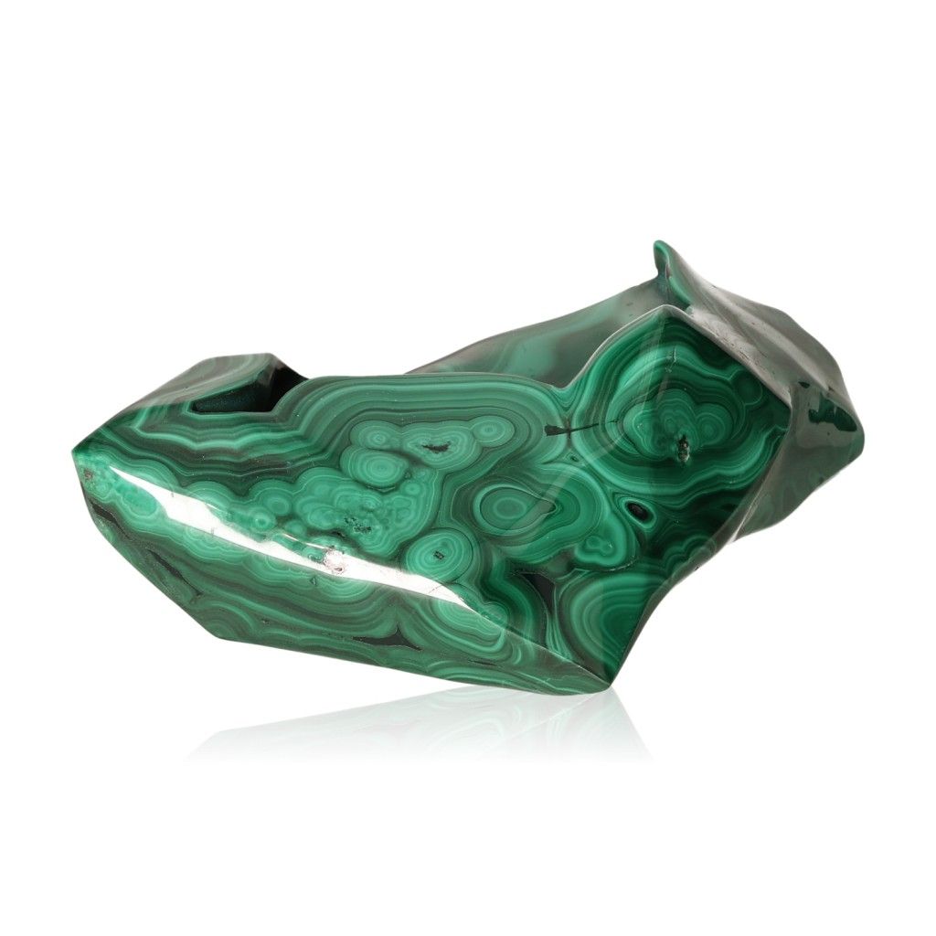 Malachite stone with soothing energy, promoting courage and optimism, polished surface showing distinctive green patterns.