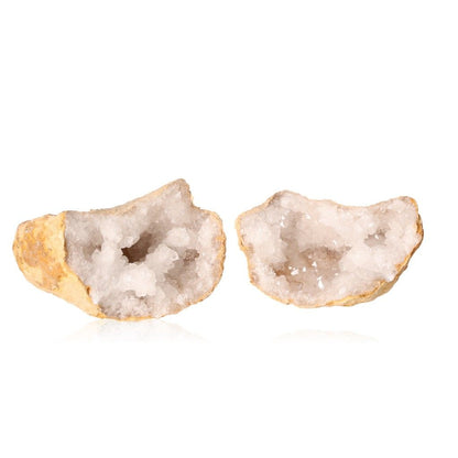 Milky quartz geode with a rugged exterior, revealing cloudy white crystals, known for purifying energy and enhancing tranquility.