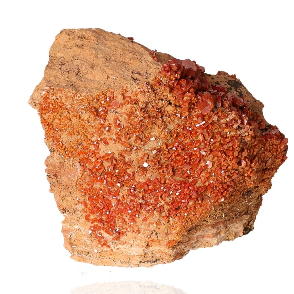 Vanadinite Druze with vibrant reddish-orange hexagonal crystals, showcasing bold colors and geometric shapes on a glassy surface.