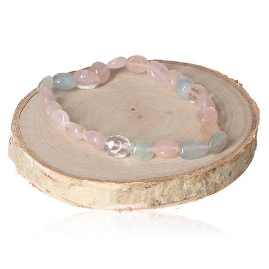 Morganite MIX bracelet with 8mm tumbled stones on a wooden surface, showcasing pastel hues and elegant design.