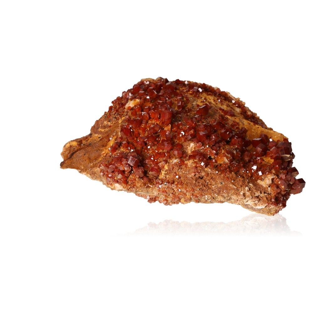 Vanadinite druzy with vibrant hexagonal crystals and a glassy surface, showcasing rich reddish-brown hues and geometric shapes.