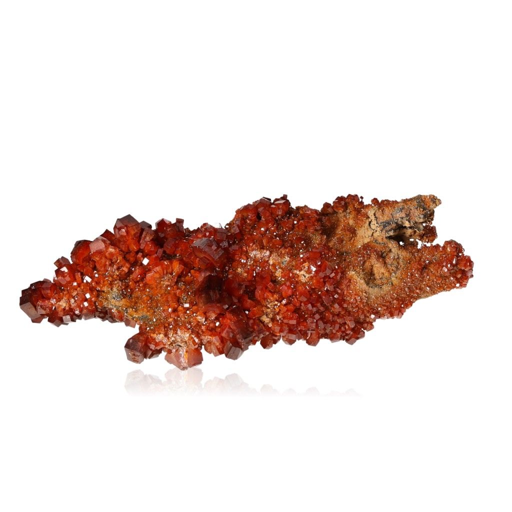 Vanadinite druze with vibrant reddish-orange hexagonal crystals and a glassy surface, showcasing its geometric beauty and bold colors.