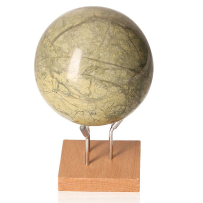 Serpentine sphere on wooden stand, promotes healing and spiritual wisdom, enhances meditation and emotional balance.