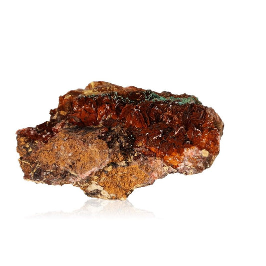 Raw brown and red mineral specimen on white background.