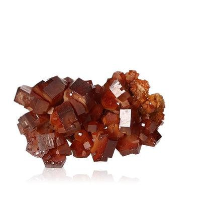 Reddish-brown vanadinite druze with hexagonal crystals and glassy surface, showcasing bold colors and geometric shapes.