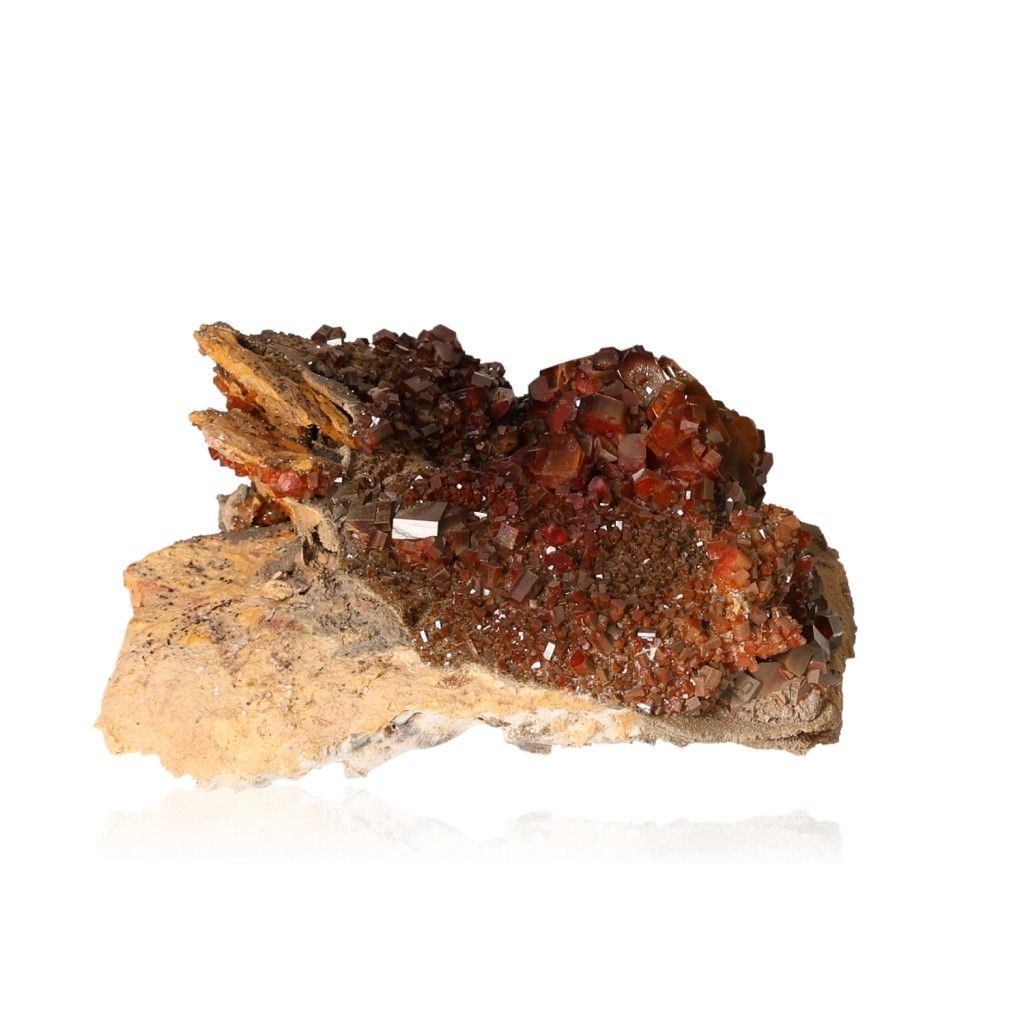 Vanadinite Druze with vibrant hexagonal crystals and glassy surface highlighting its reddish-brown and orange hues.