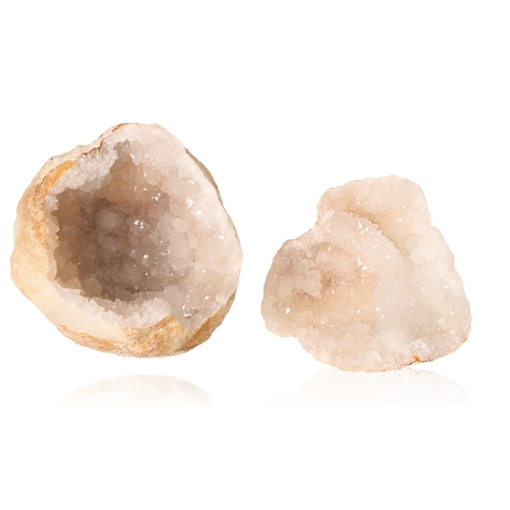 Milky quartz geodes revealing sparkling, cloudy white crystals, known for purifying energy and enhancing tranquility and clarity.