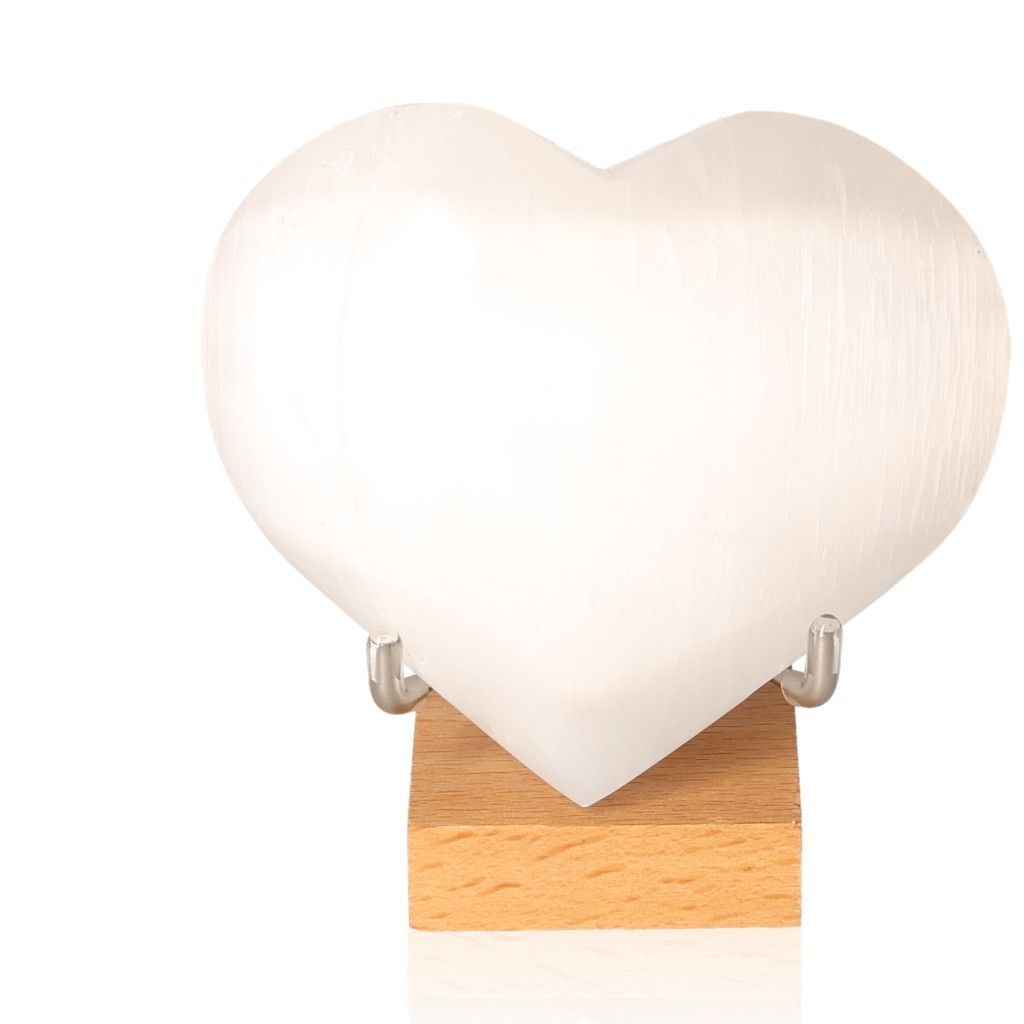 White selenite heart crystal on wooden stand for spiritual growth and mindful living by Sylvia Crystals