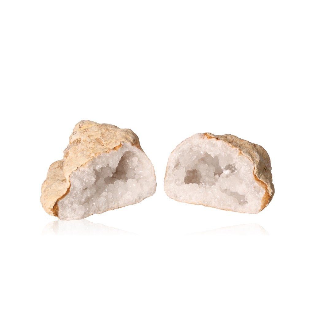 Milky quartz geode split open, revealing sparkling cloudy white crystals and rugged earthy outer shell, perfect for energy balancing.